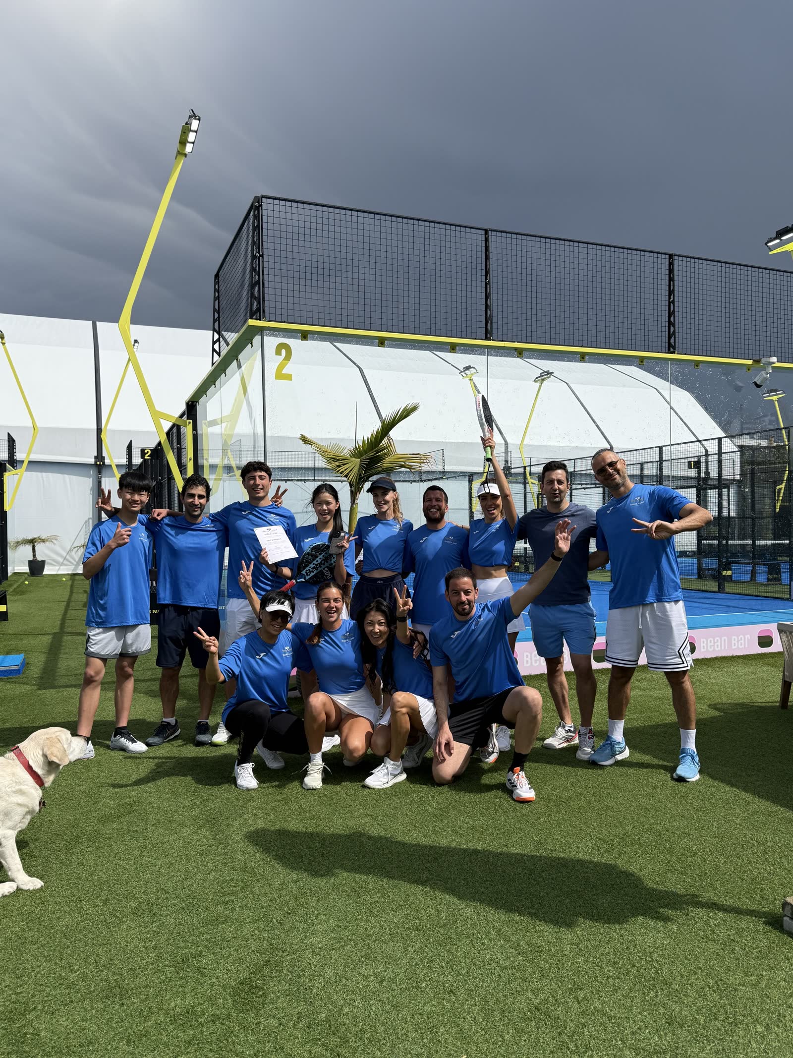 Padel Camp Cyprus group celebrating with raised rackets after camp