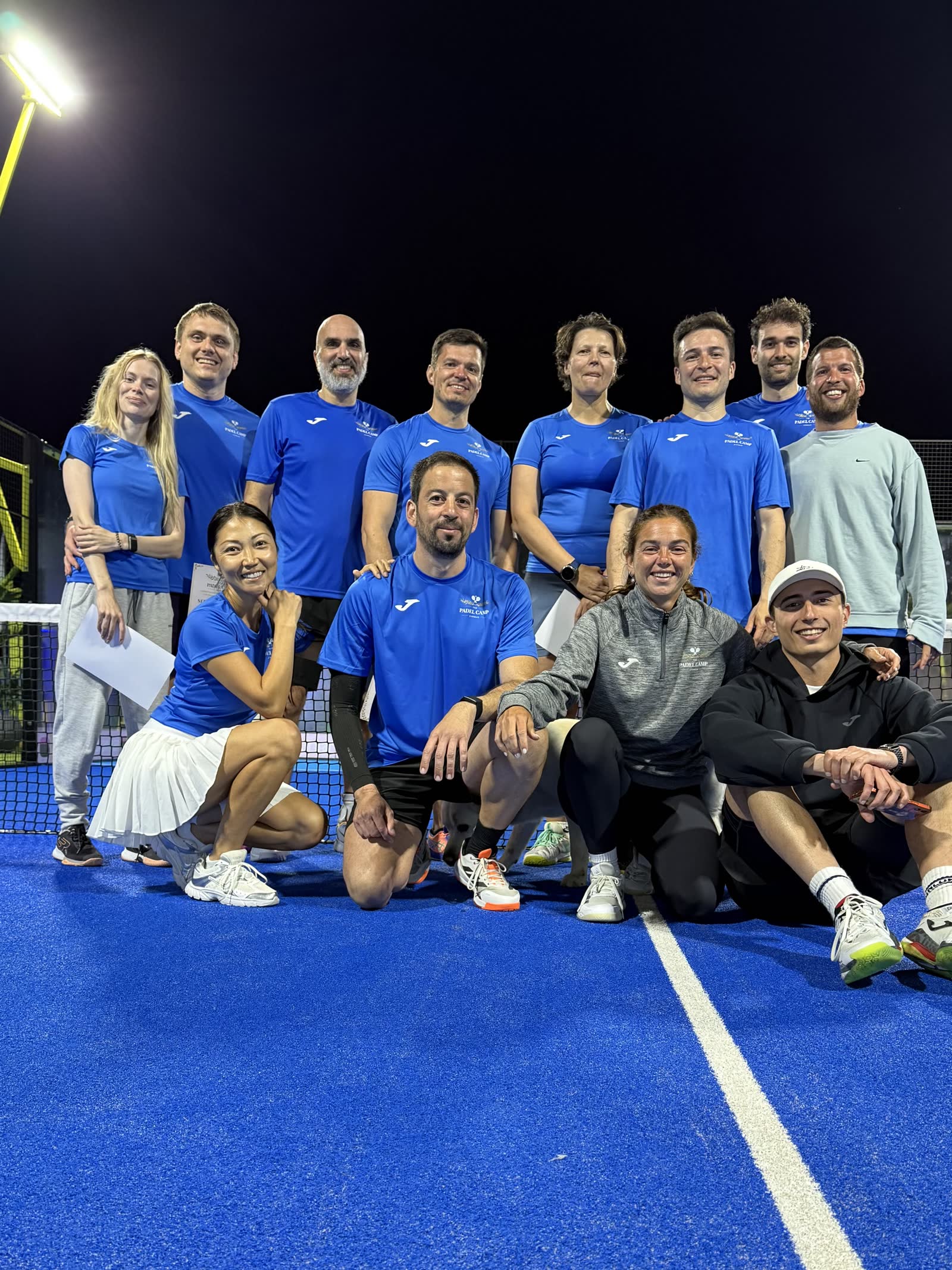 Padel Camp Cyprus evening session group photo under floodlights