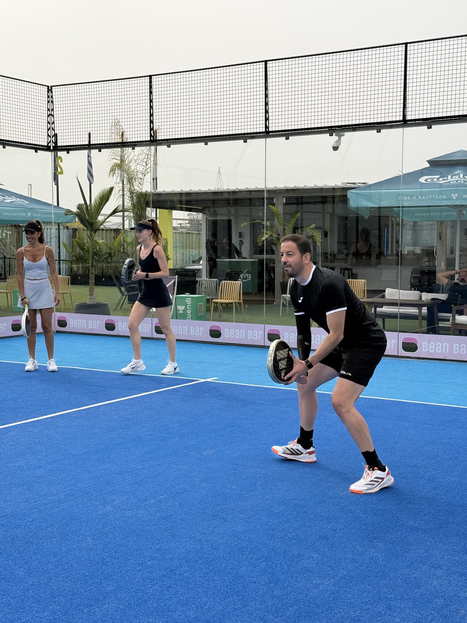 Padel Camp Cyprus players and coach in ready position during a training session
