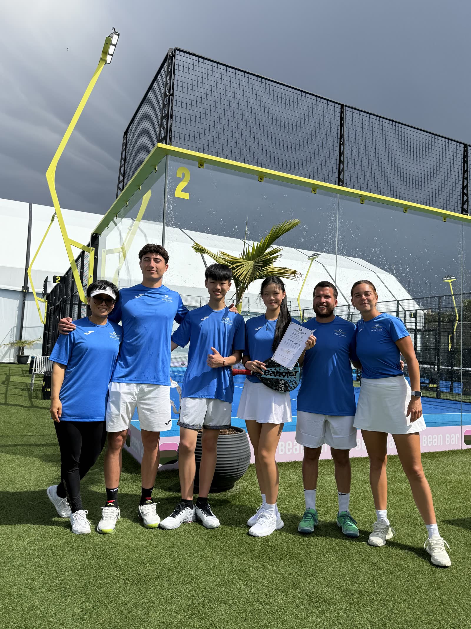 Padel Camp Cyprus group celebrating with a certificate of completion